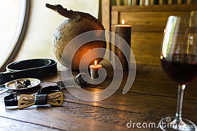 Menâ€™s rings in bronze plate on a wooden table. Menâ€™s accessorizes, necktie, belt, watch Stock Photo